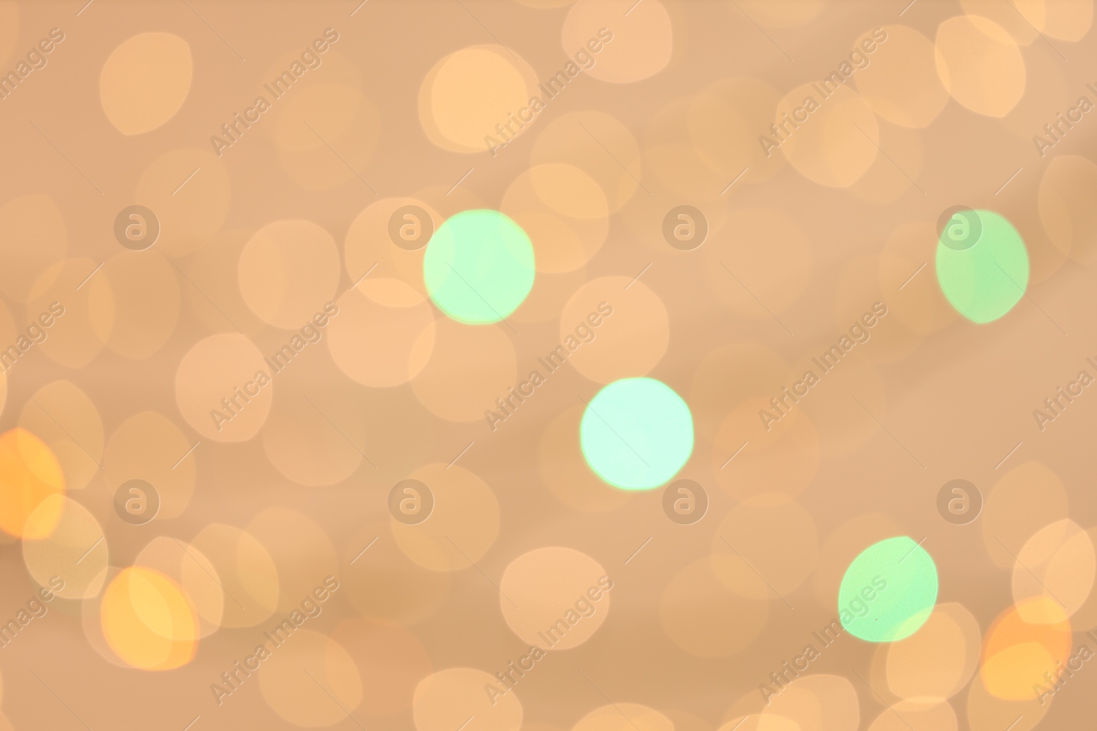 Photo of Blurred view of colorful lights on light background, bokeh effect