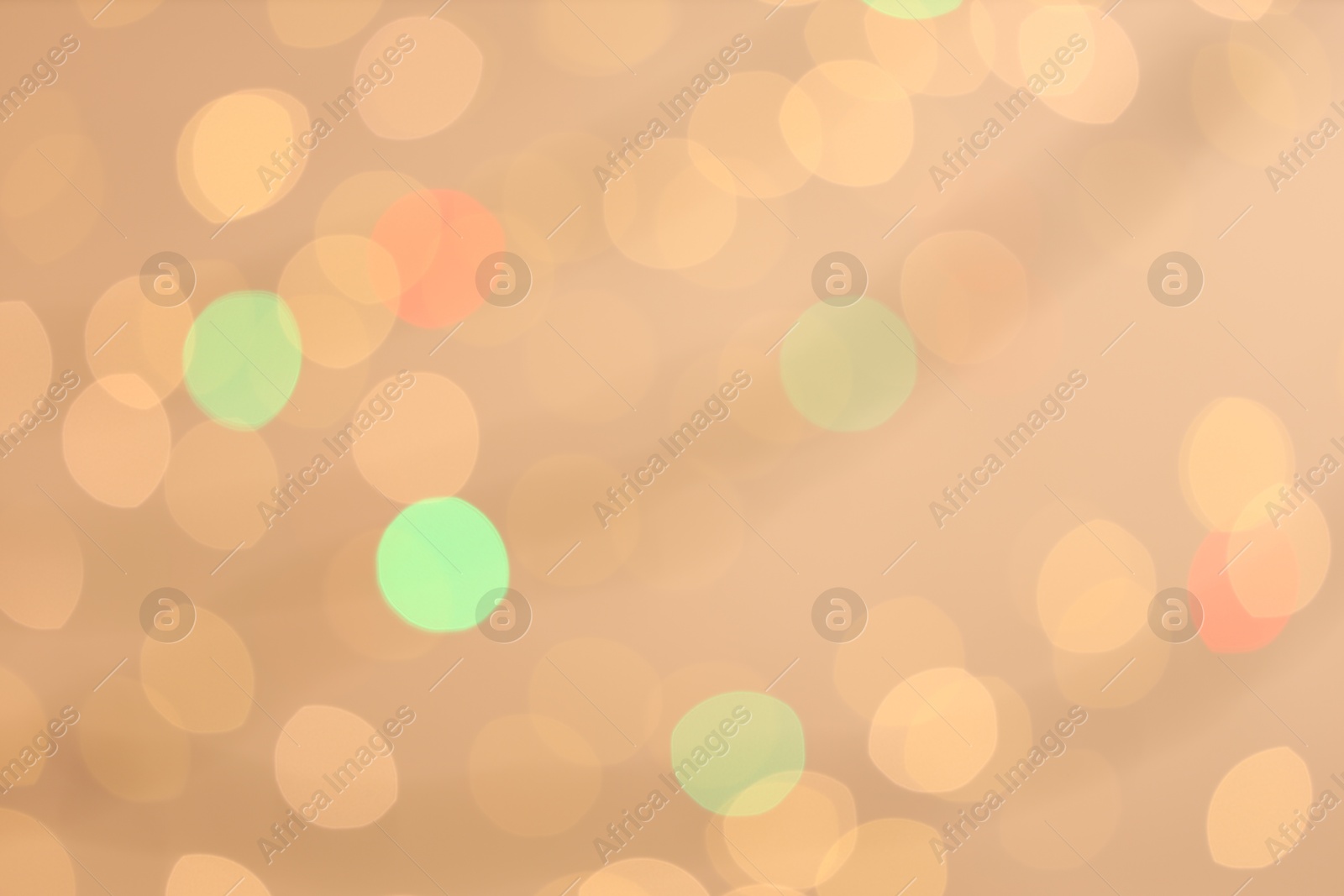 Photo of Blurred view of colorful lights on light background, bokeh effect