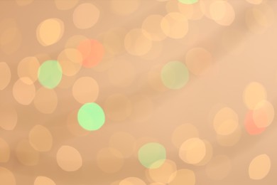 Photo of Blurred view of colorful lights on light background, bokeh effect