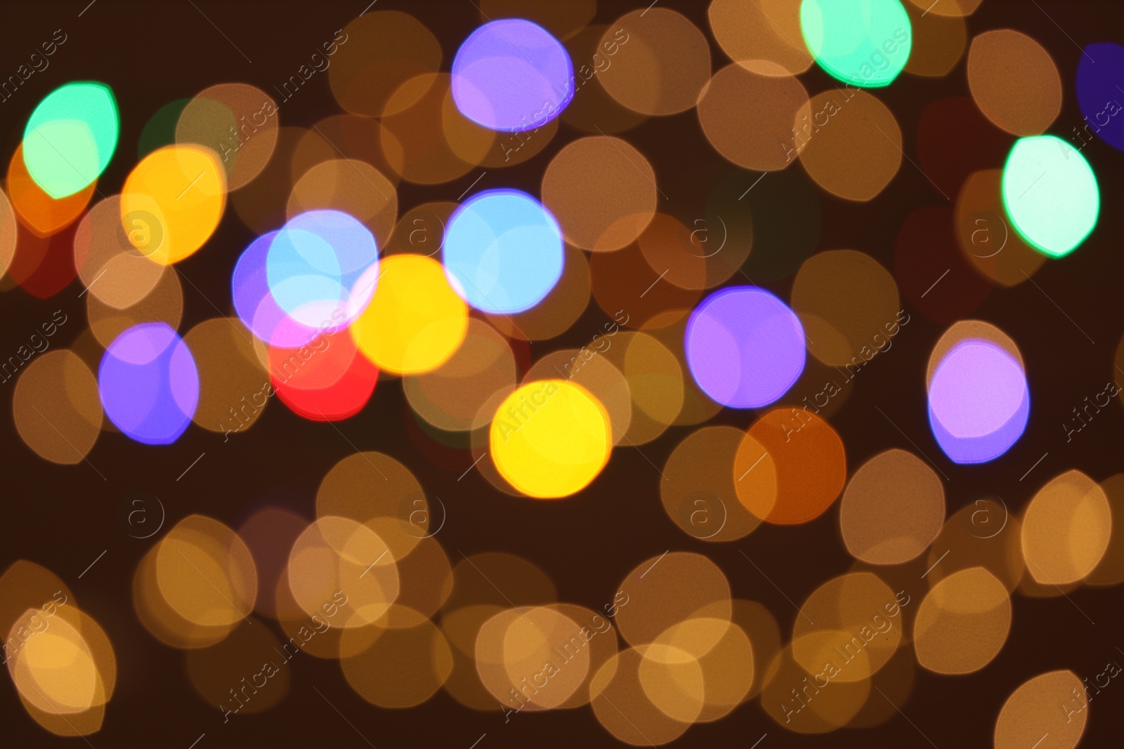 Photo of Blurred view of colorful lights on dark background, bokeh effect