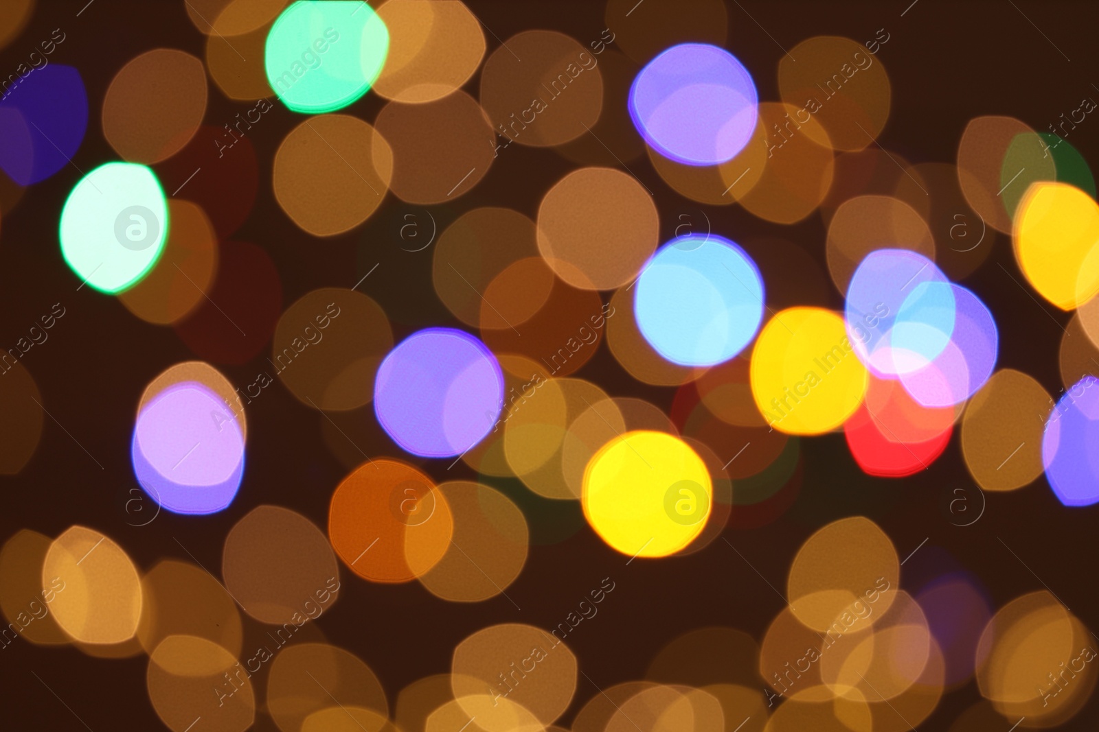 Photo of Blurred view of colorful lights on dark background, bokeh effect