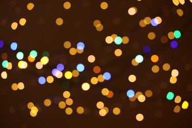 Photo of Blurred view of colorful lights on dark background, bokeh effect