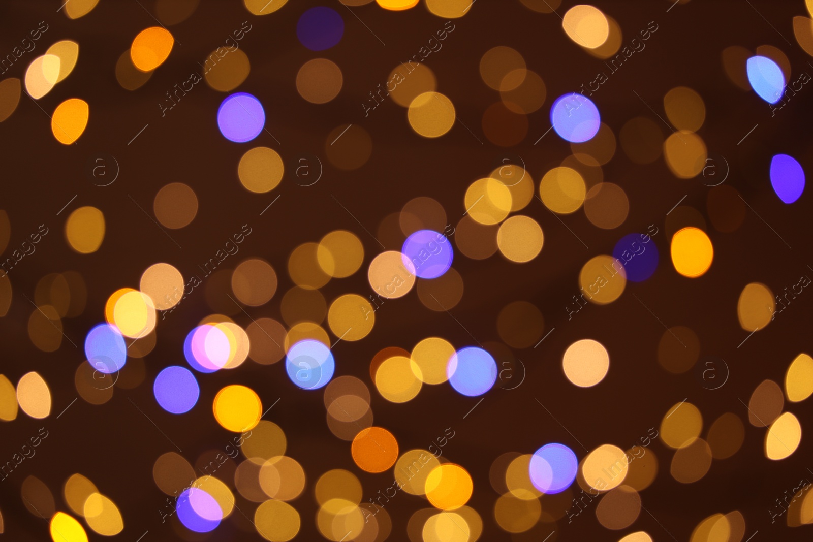 Photo of Blurred view of colorful lights on dark background, bokeh effect