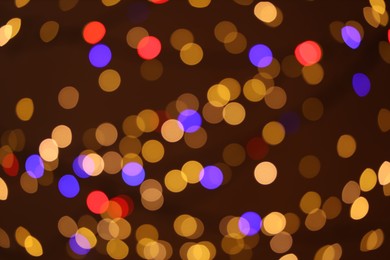 Photo of Blurred view of colorful lights on dark background, bokeh effect