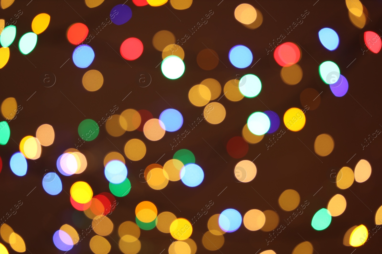 Photo of Blurred view of colorful lights on dark background, bokeh effect