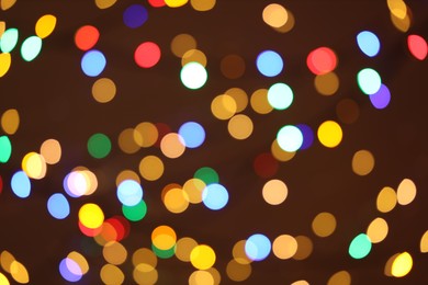 Photo of Blurred view of colorful lights on dark background, bokeh effect