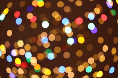 Photo of Blurred view of colorful lights on dark background, bokeh effect