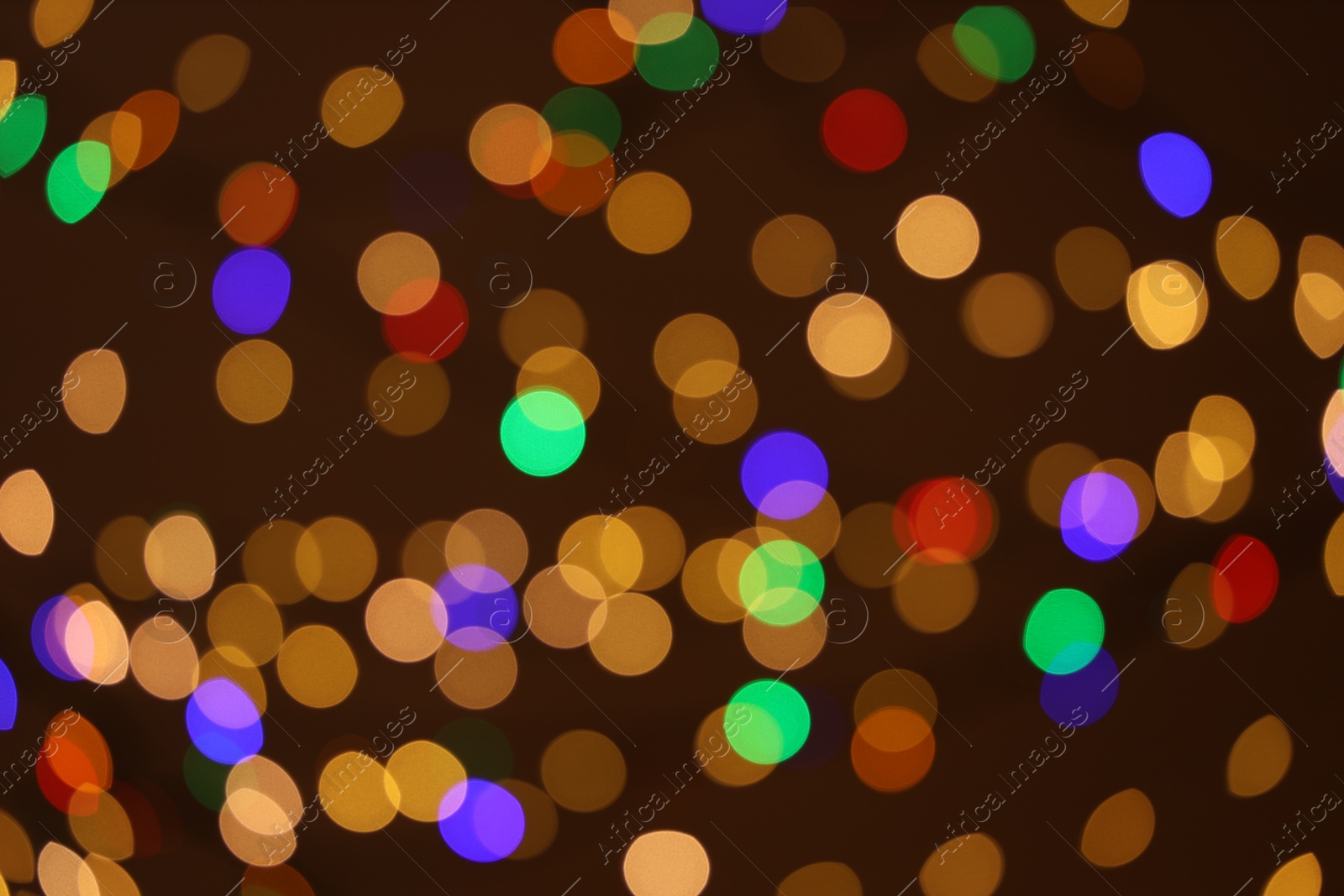 Photo of Blurred view of colorful lights on dark background, bokeh effect