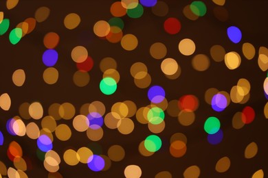 Photo of Blurred view of colorful lights on dark background, bokeh effect