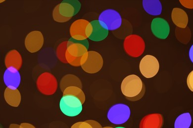 Photo of Blurred view of colorful lights on dark background, bokeh effect