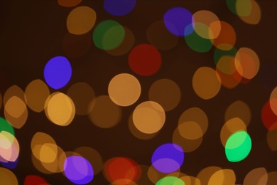 Photo of Blurred view of colorful lights on dark background, bokeh effect