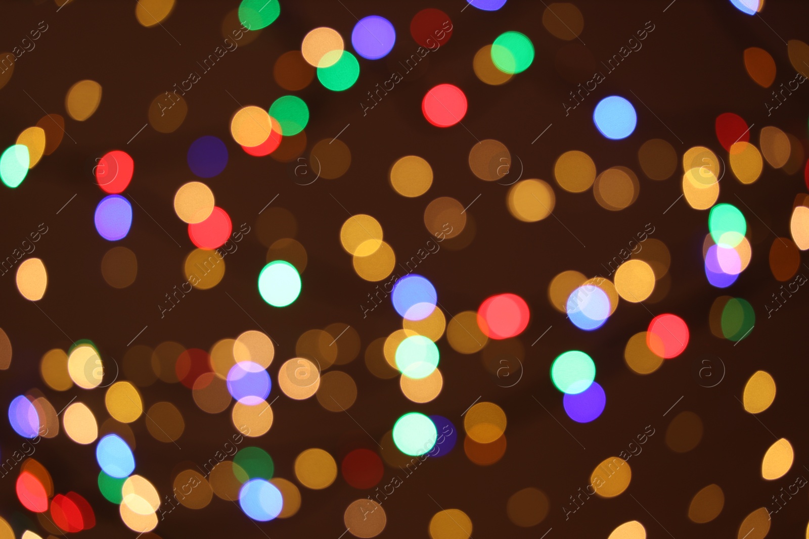 Photo of Blurred view of colorful lights on dark background, bokeh effect