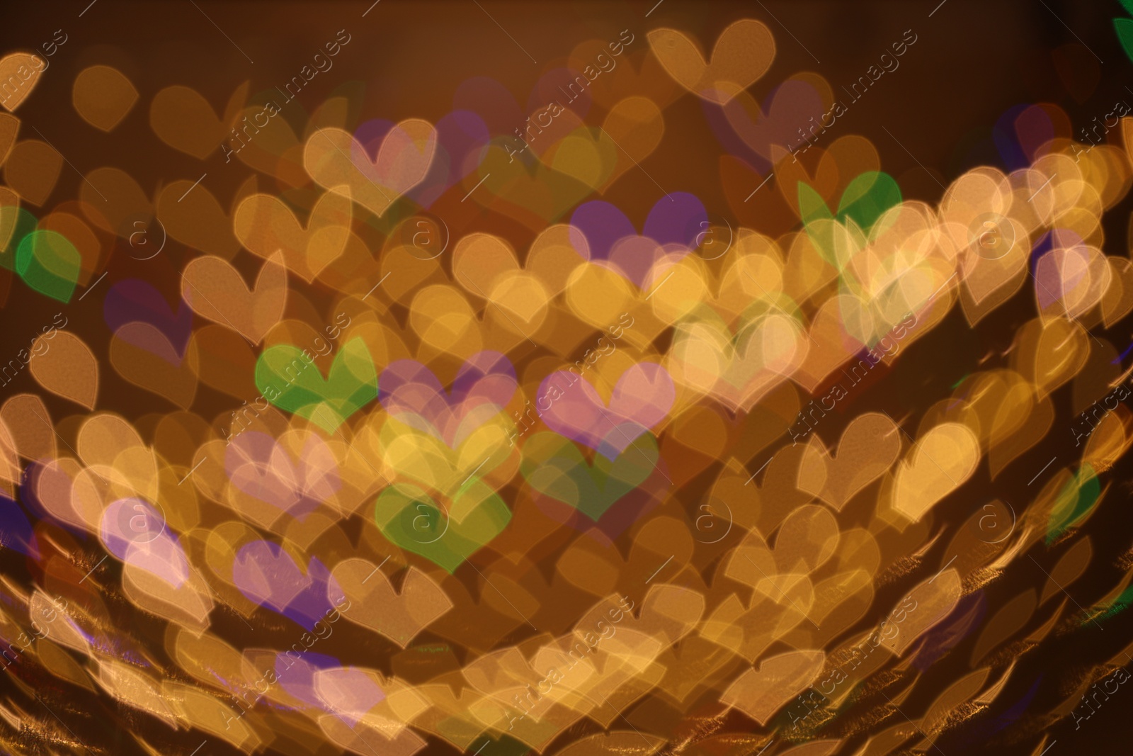 Photo of Blurred view of heart shaped lights on dark background, bokeh effect