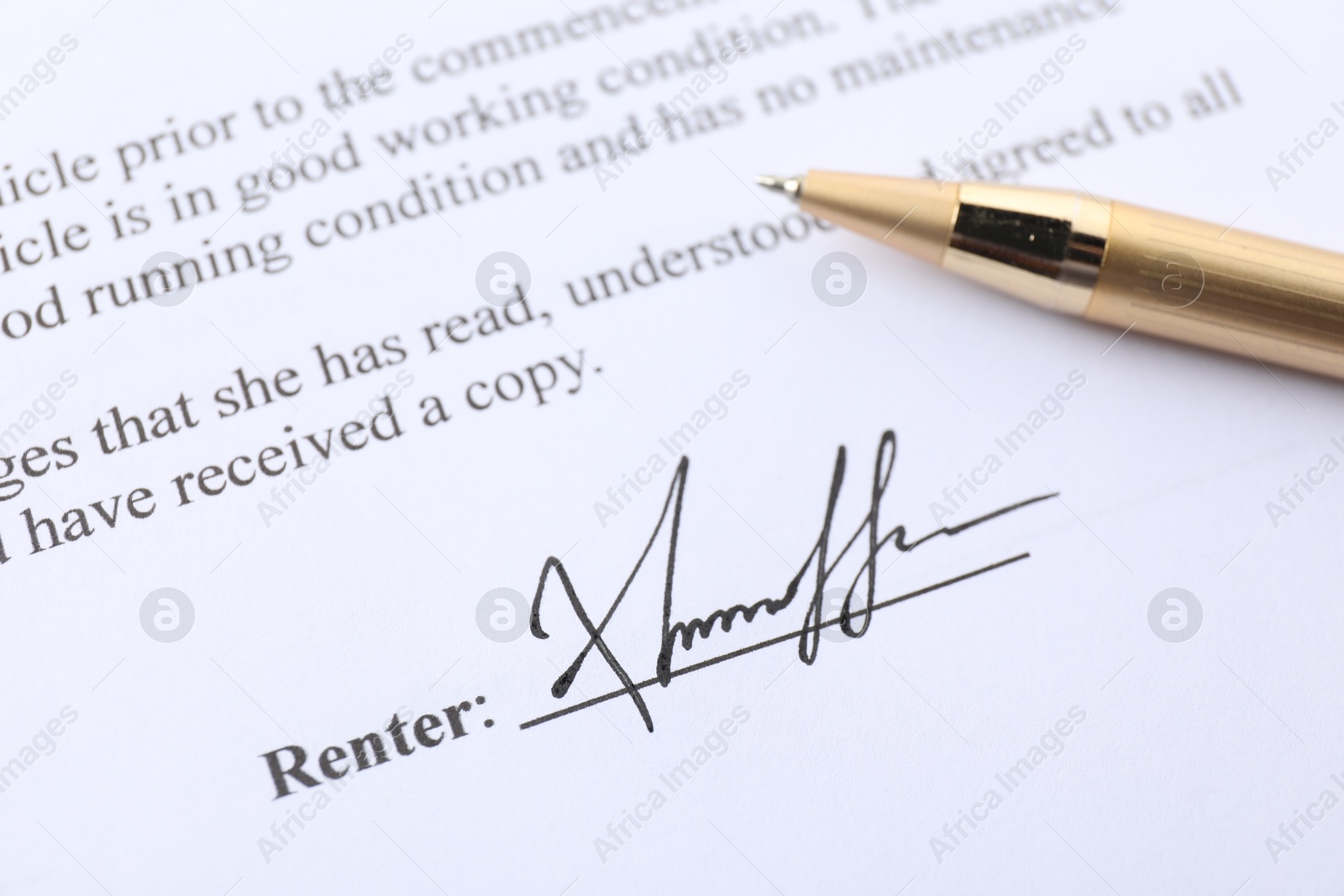 Photo of Signature and pen on paperwork, closeup view