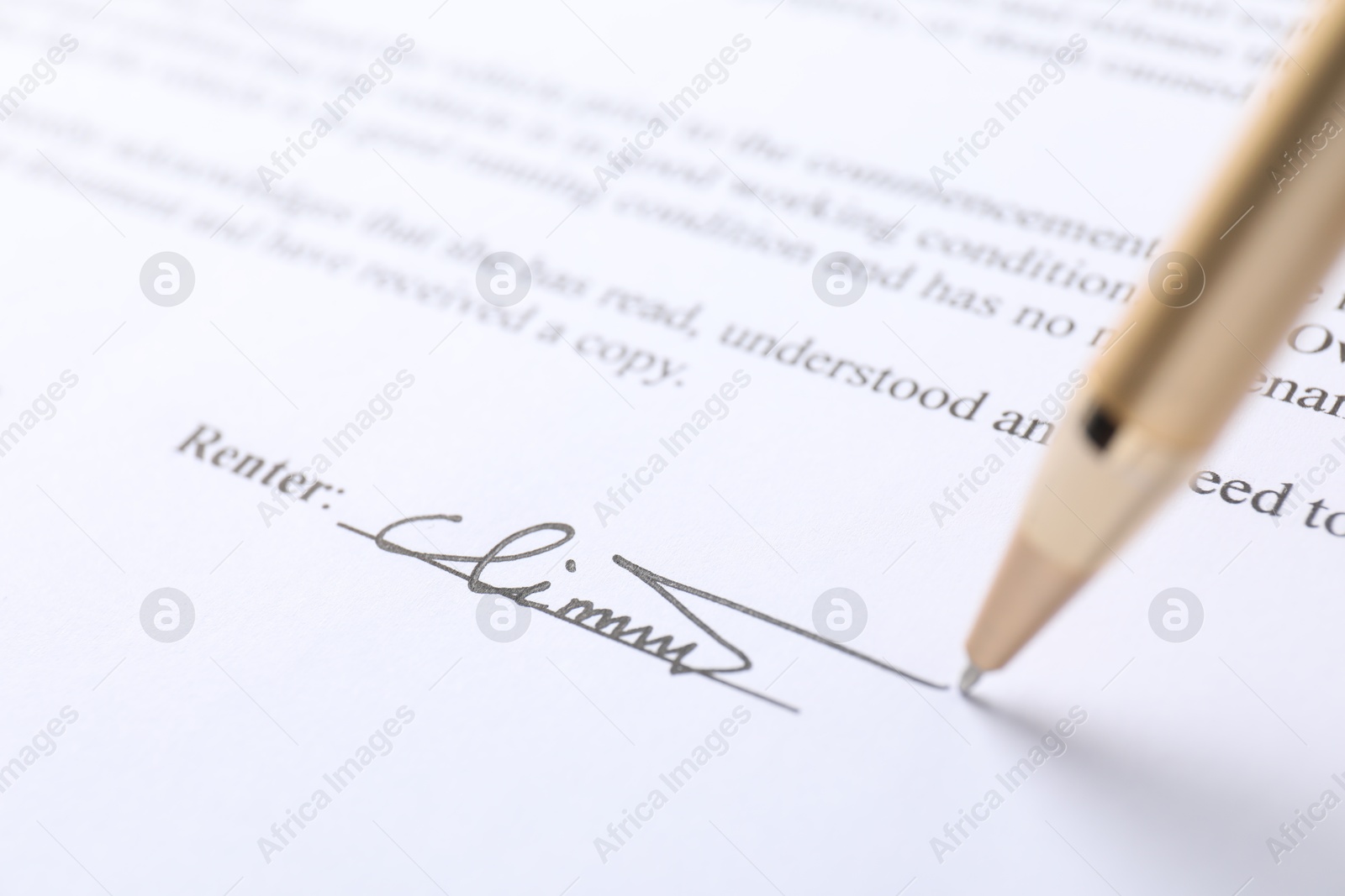 Photo of Pen leaving signature on contract, closeup view