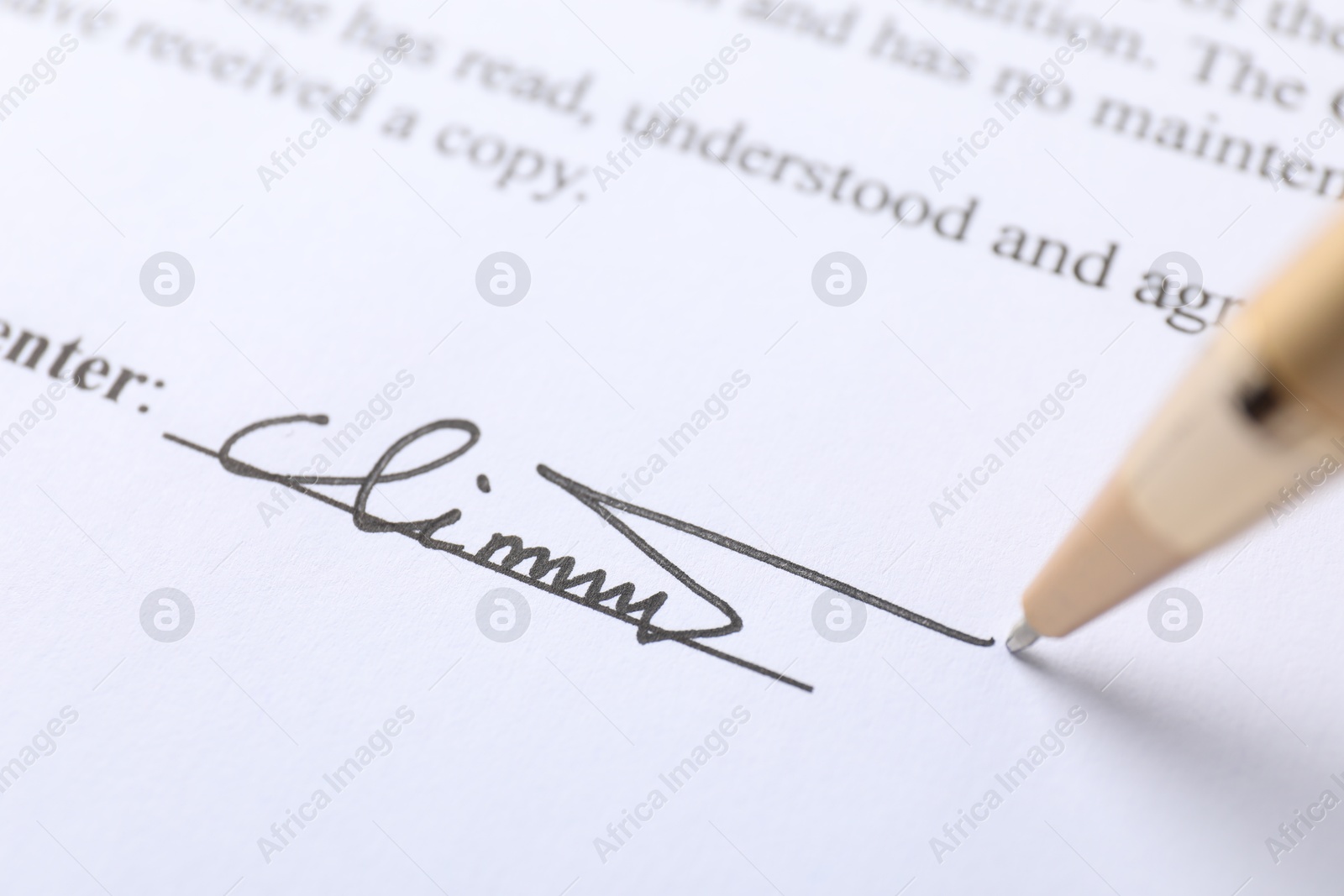 Photo of Pen leaving signature on contract, closeup view