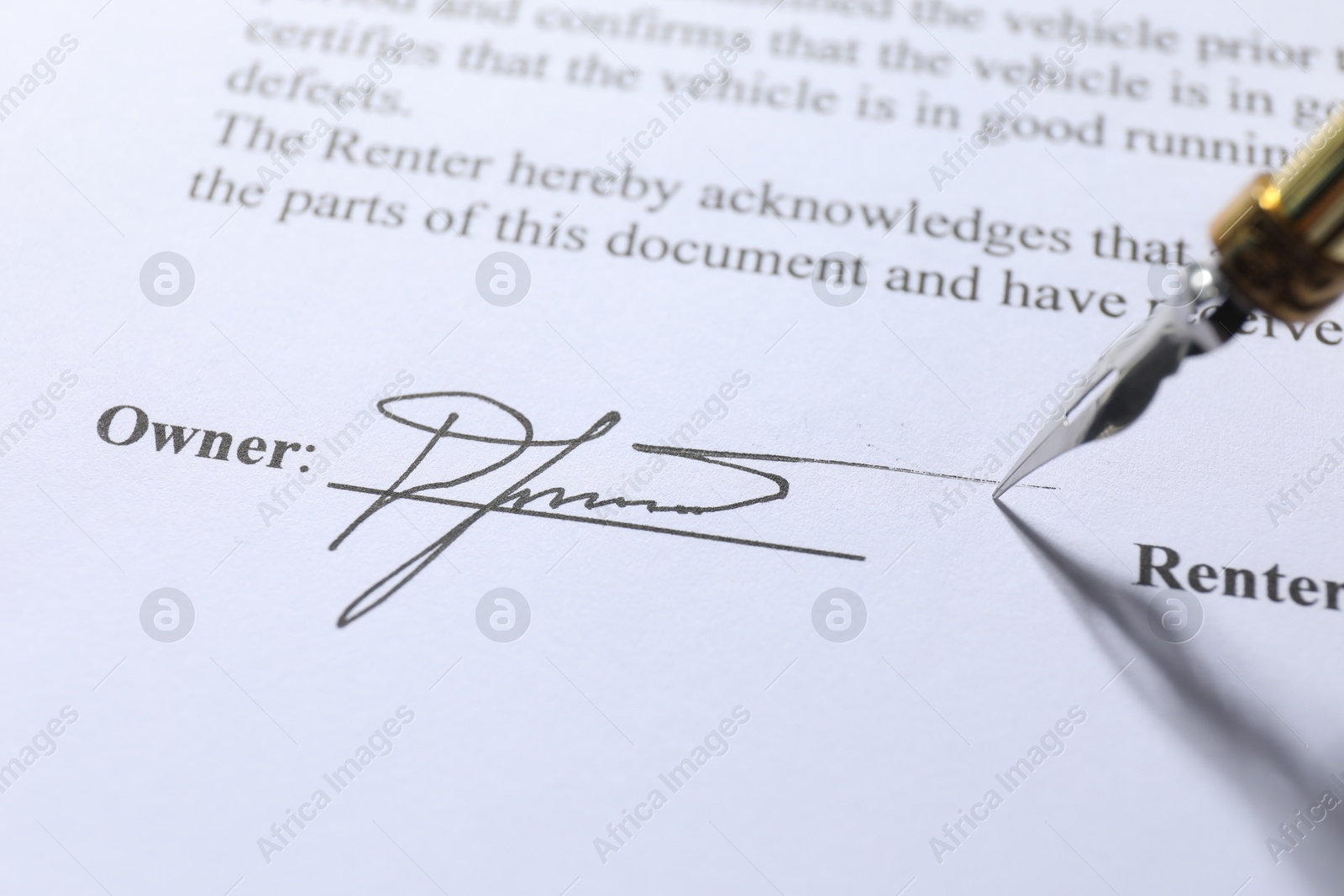 Photo of Fountain pen leaving signature on contract, closeup