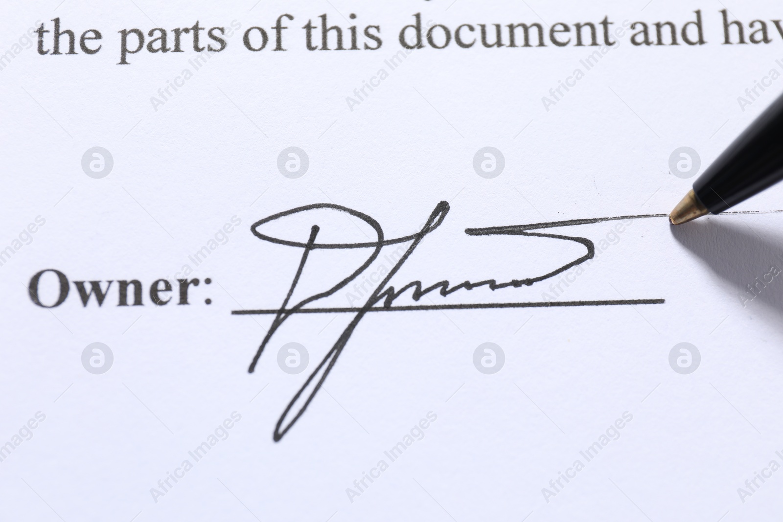 Photo of Pen leaving signature on contract, closeup view