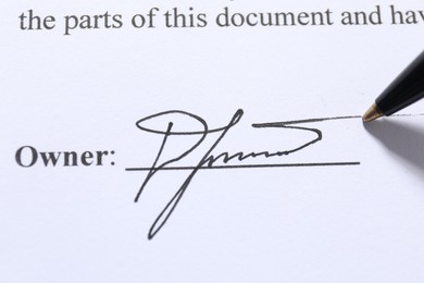 Photo of Pen leaving signature on contract, closeup view