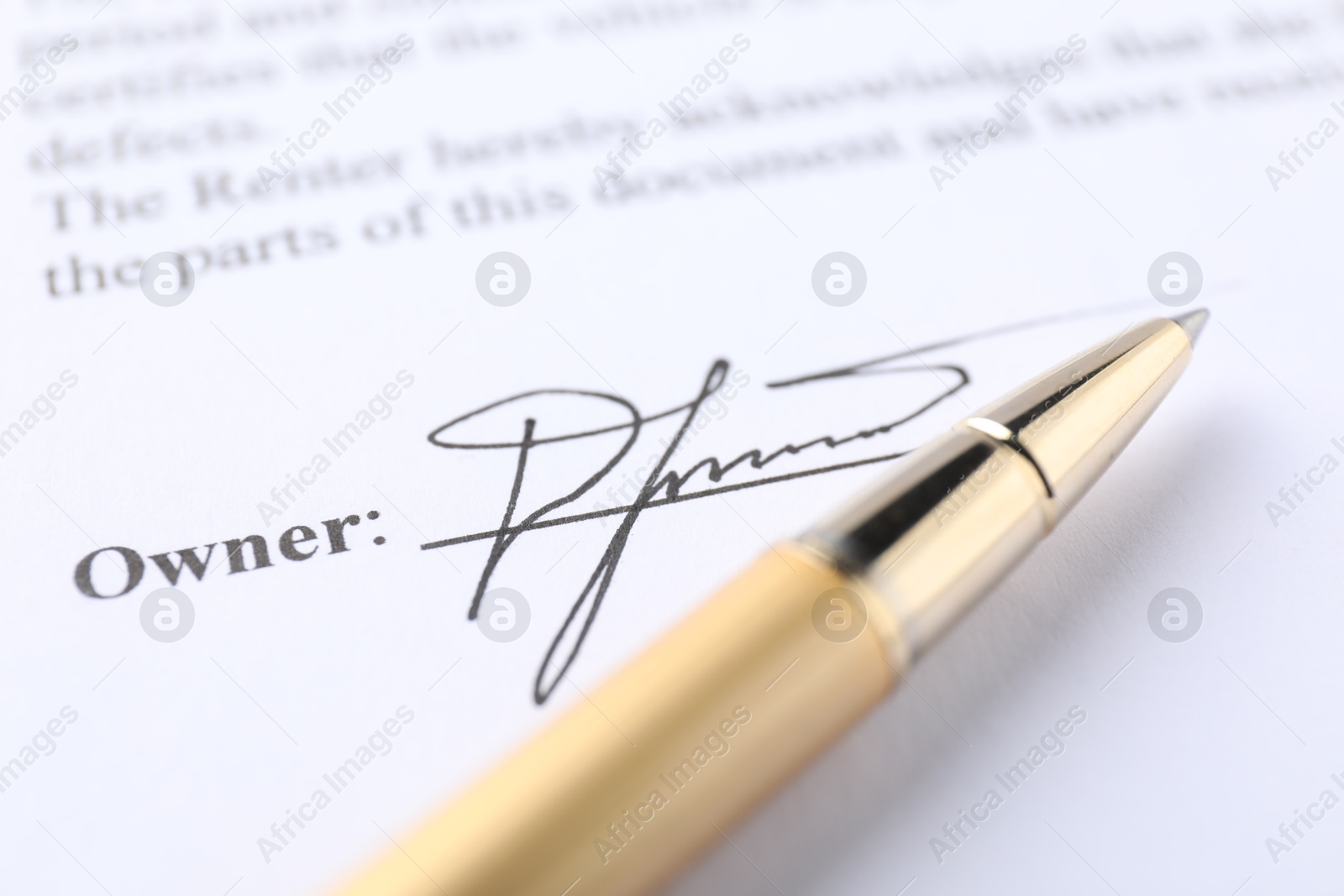 Photo of Signature and pen on paperwork, closeup view