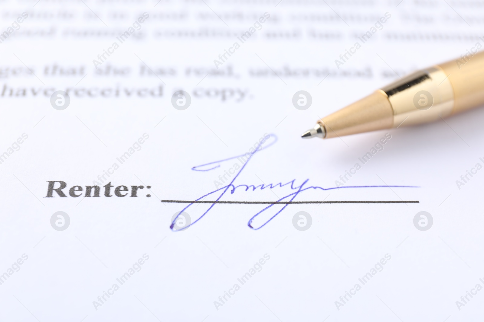 Photo of Signature and pen on paperwork, closeup view