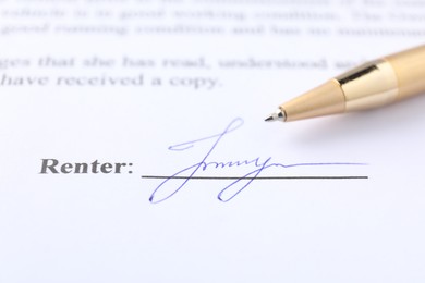 Photo of Signature and pen on paperwork, closeup view