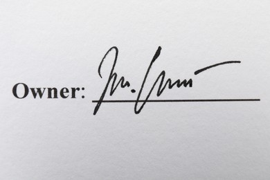 Photo of Owner's handwritten signature on paperwork, closeup view