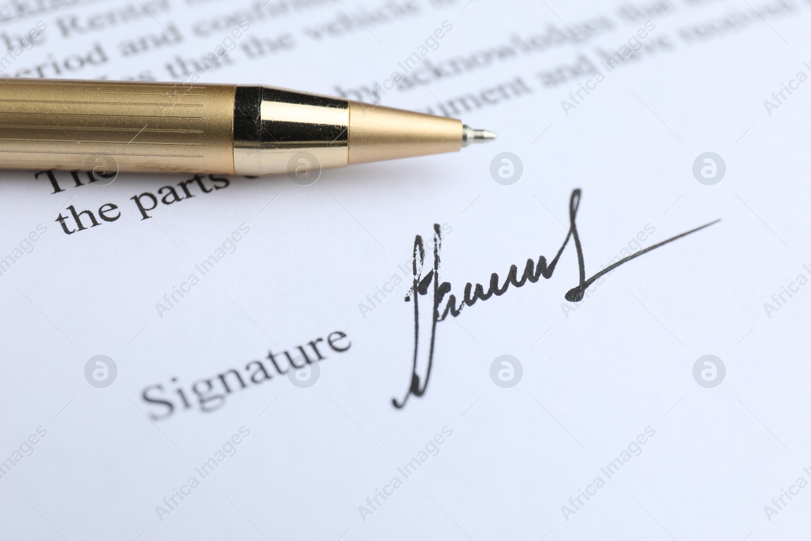 Photo of Ballpoint pen and signature on contract, closeup