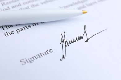 Photo of Ballpoint pen and signature on contract, closeup