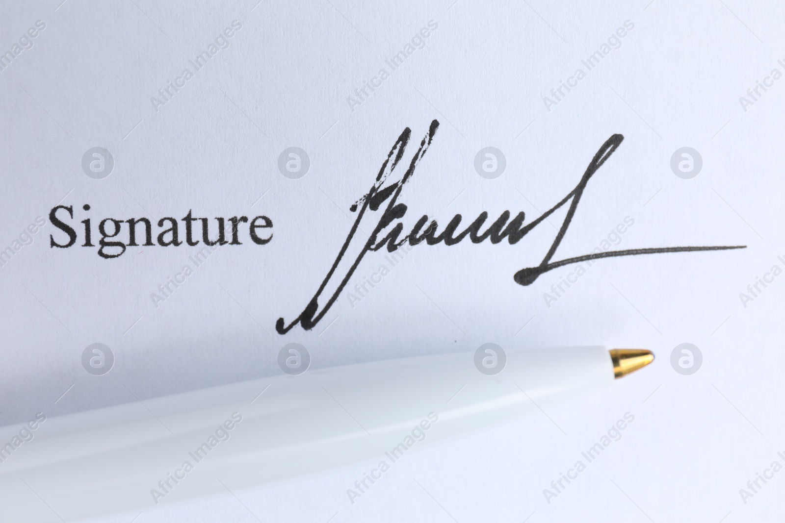 Photo of Ballpoint pen and signature on contract, top view