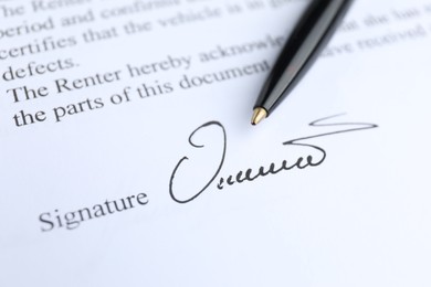 Photo of Ballpoint pen and signature on contract, closeup