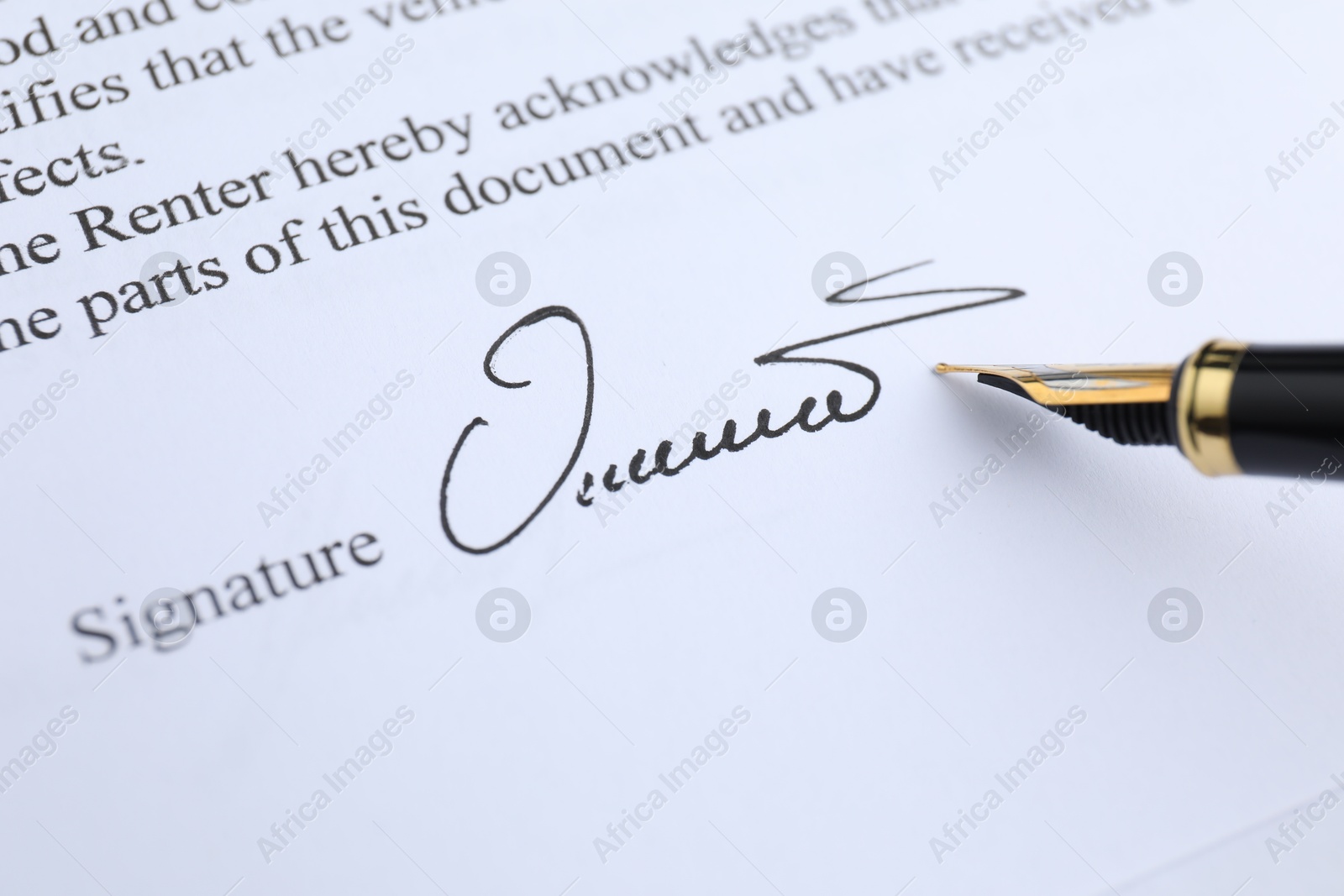 Photo of Fountain pen leaving signature on contract, closeup