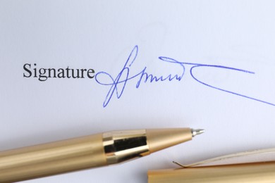 Photo of Ballpoint pen and signature on contract, top view