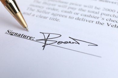 Photo of Ballpoint pen and signature on contract, closeup