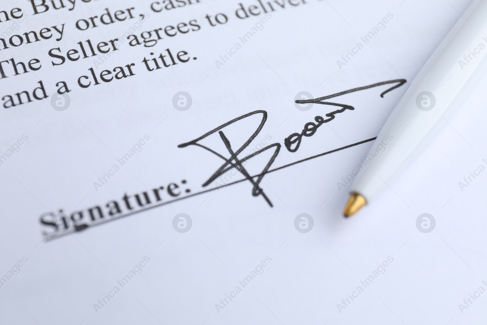 Photo of Ballpoint pen and signature on contract, closeup