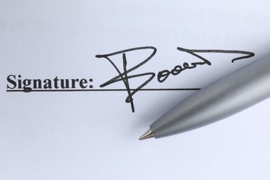 Photo of Ballpoint pen and signature on contract, top view