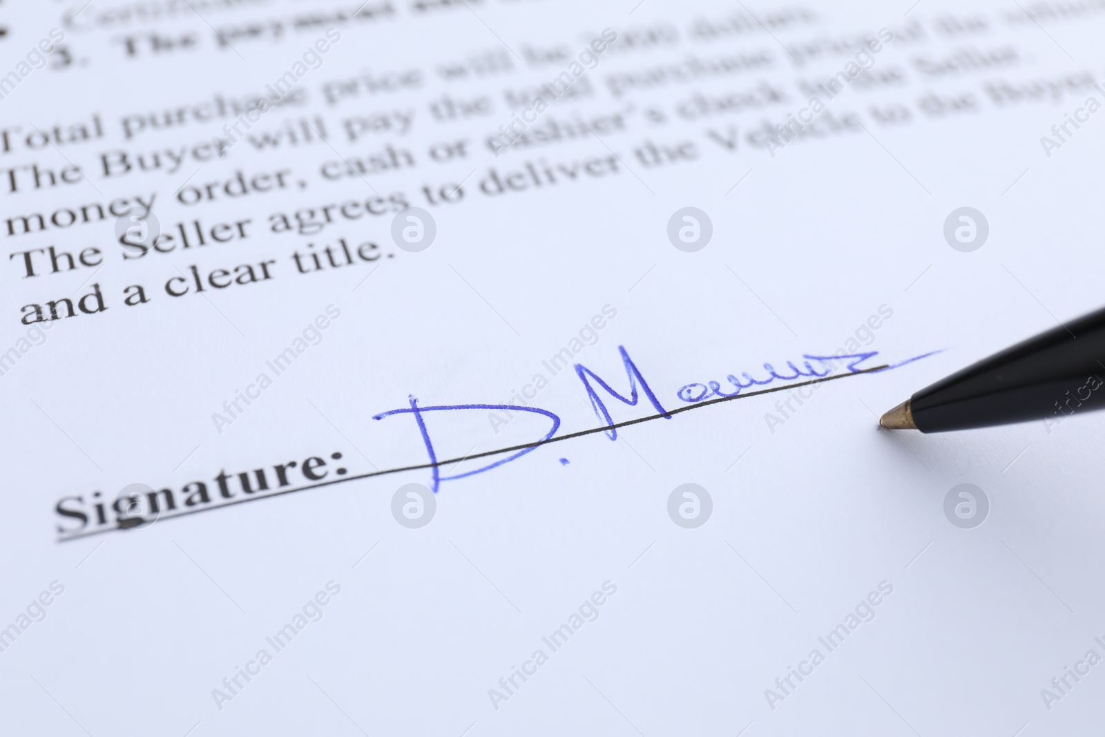 Photo of Ballpoint pen and signature on contract, closeup