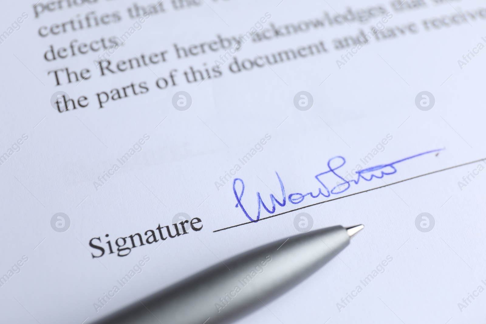 Photo of Ballpoint pen and signature on contract, closeup