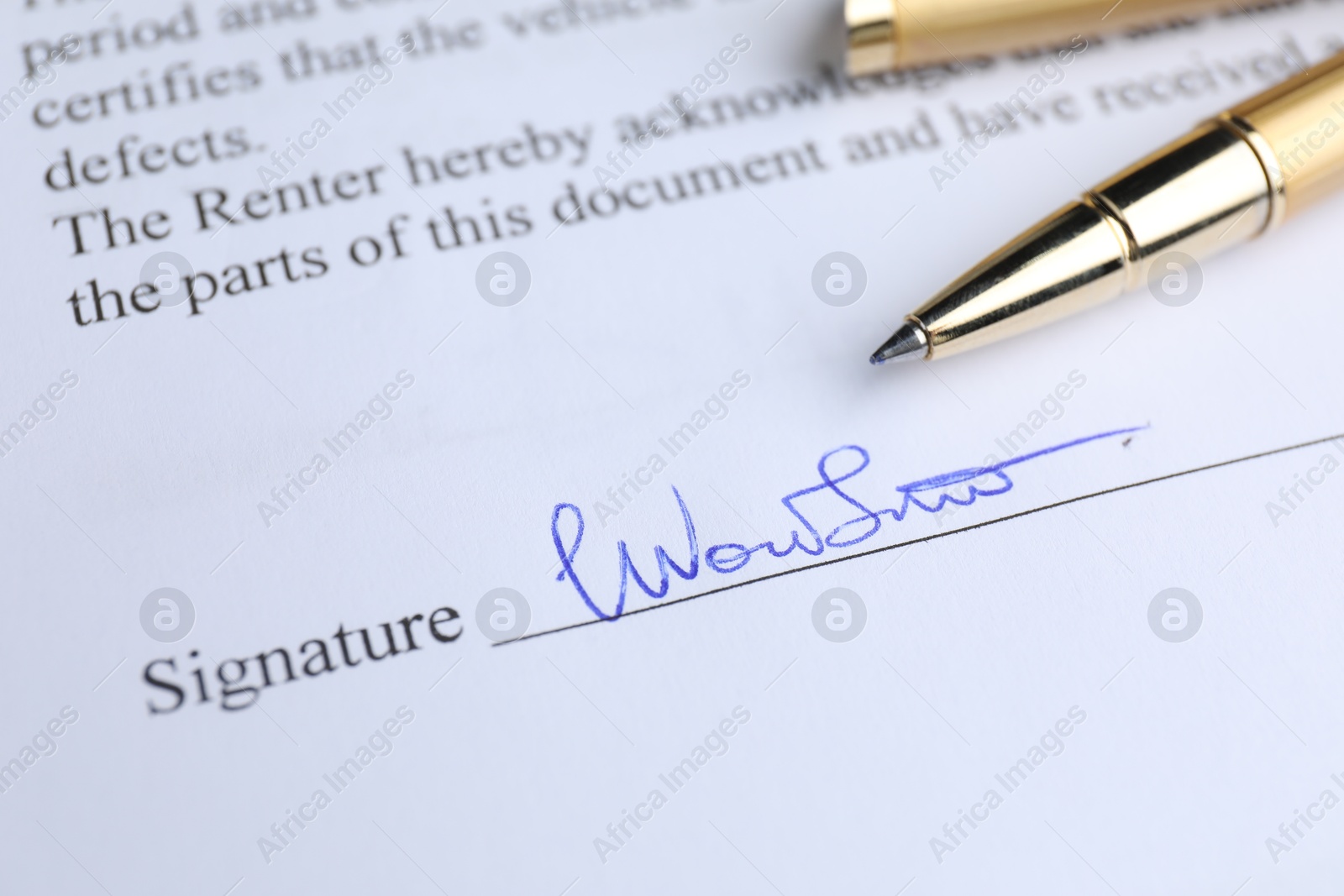 Photo of Ballpoint pen and signature on contract, closeup