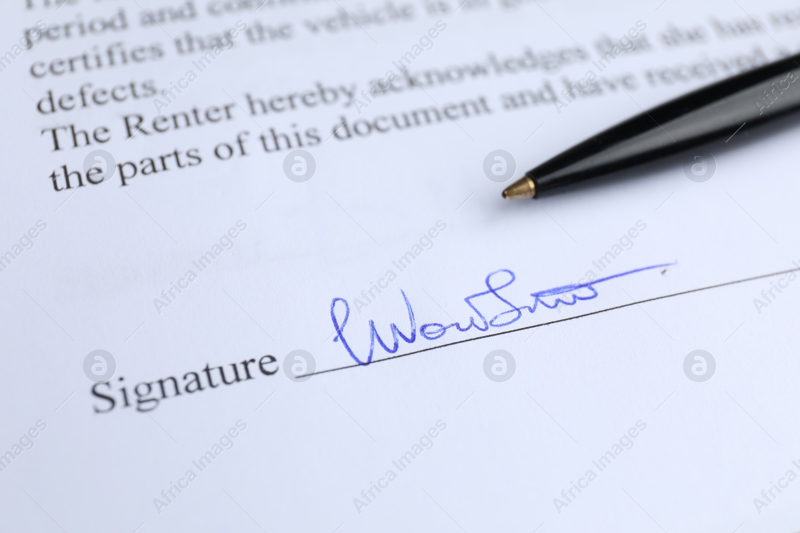 Photo of Ballpoint pen and signature on contract, closeup