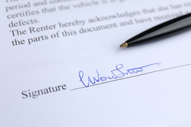 Photo of Ballpoint pen and signature on contract, closeup