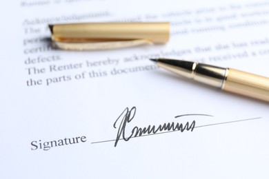 Photo of Ballpoint pen and signature on contract, closeup