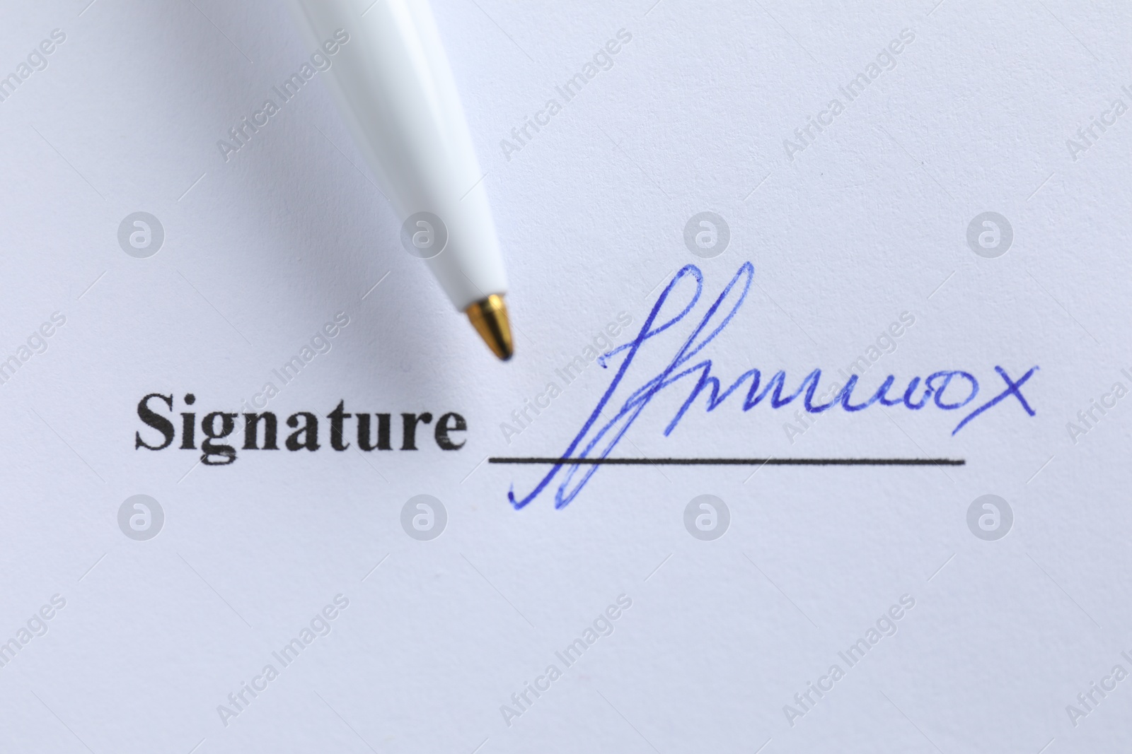 Photo of Ballpoint pen and signature on contract, top view