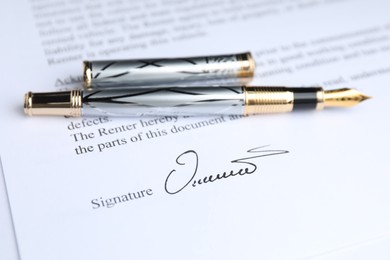 Photo of Fountain pen and signature on contract, closeup