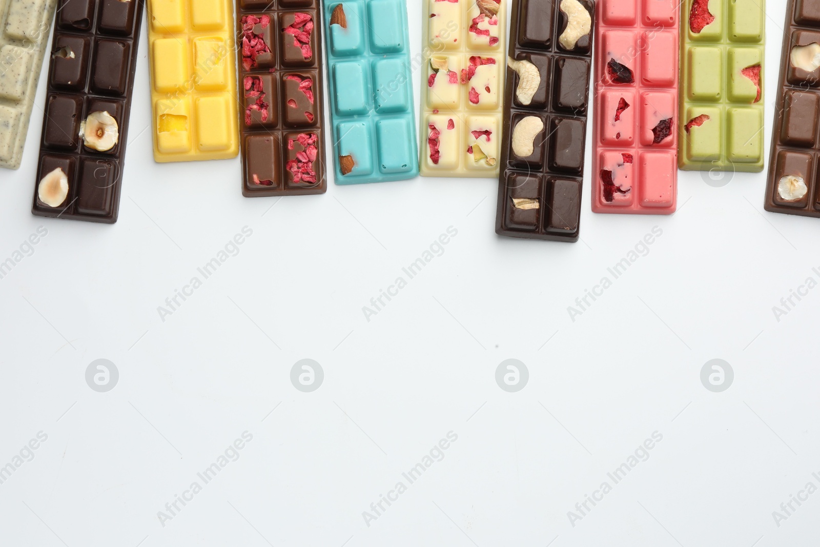 Photo of Different tasty chocolate bars on white background, flat lay. Space for text