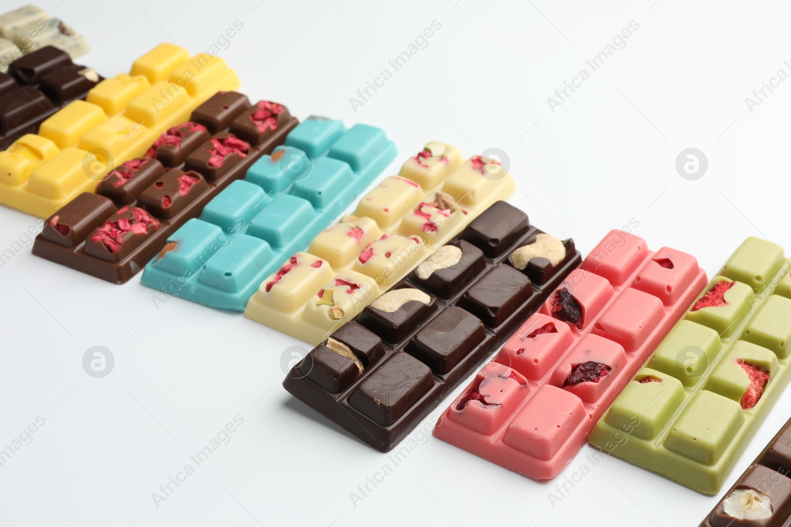 Photo of Different tasty chocolate bars on white background, closeup