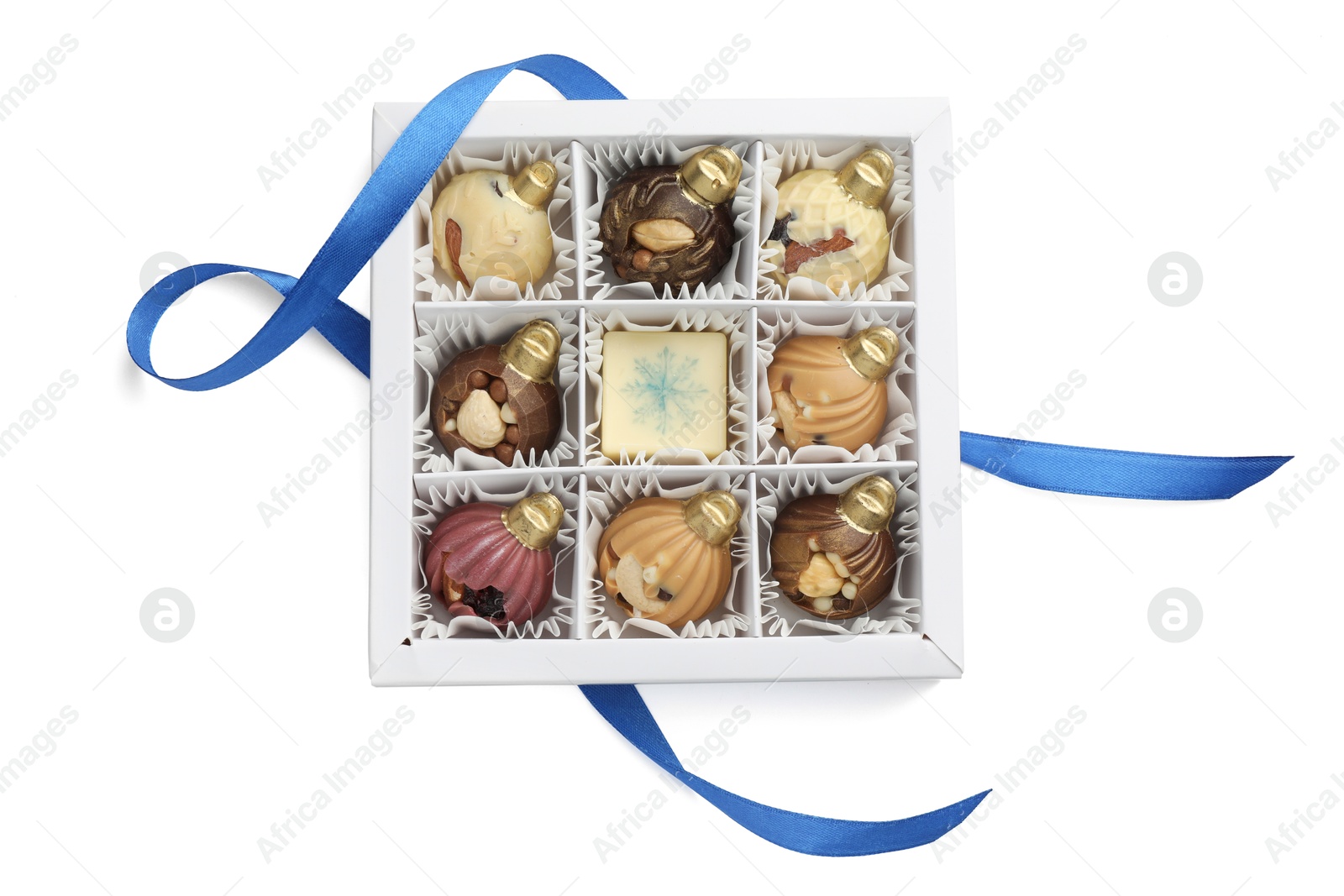 Photo of Box with delicious chocolate in shape of Christmas ornaments isolated on white, top view