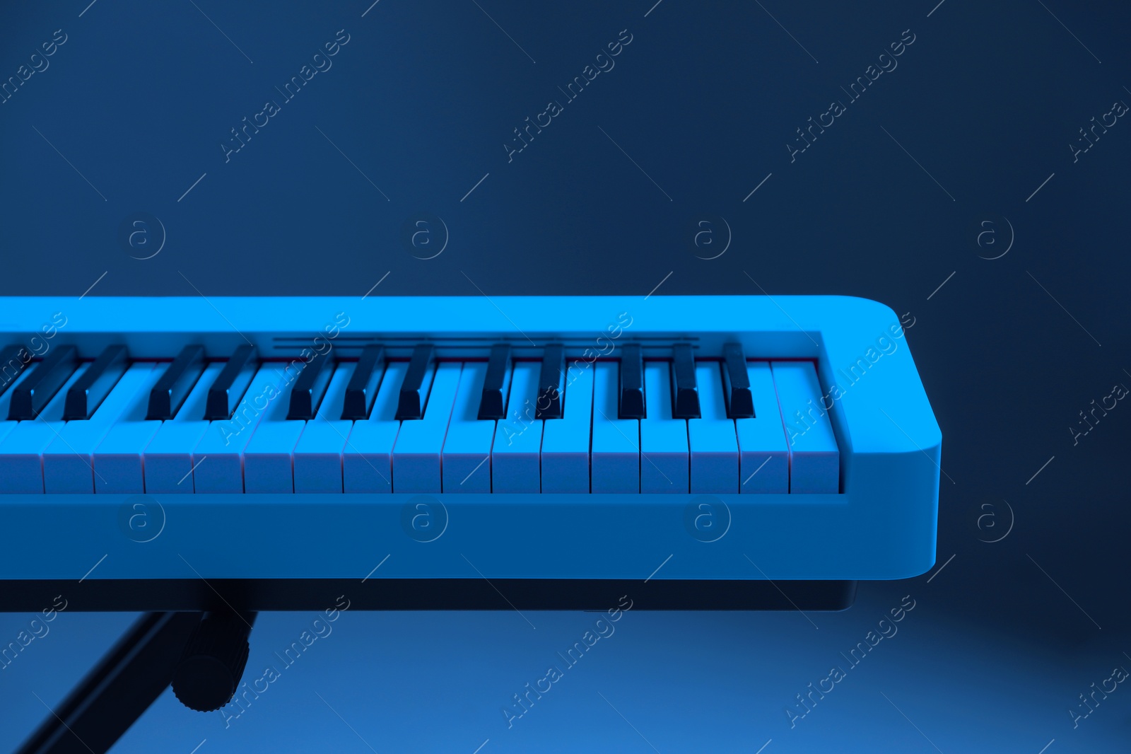 Image of Synthesizer, closeup. Toned in blue color. Electronic musical instrument