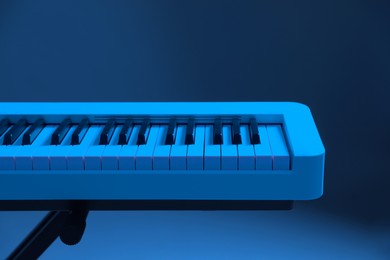 Image of Synthesizer, closeup. Toned in blue color. Electronic musical instrument