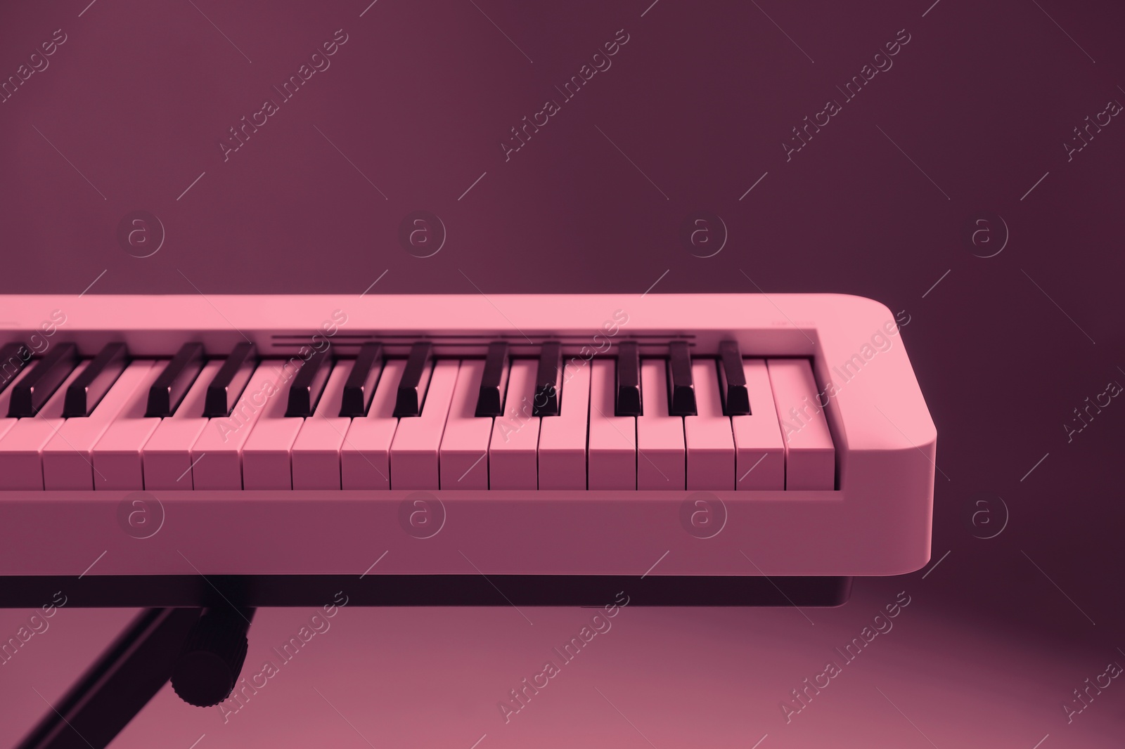 Image of Synthesizer, closeup. Toned in pink color. Electronic musical instrument